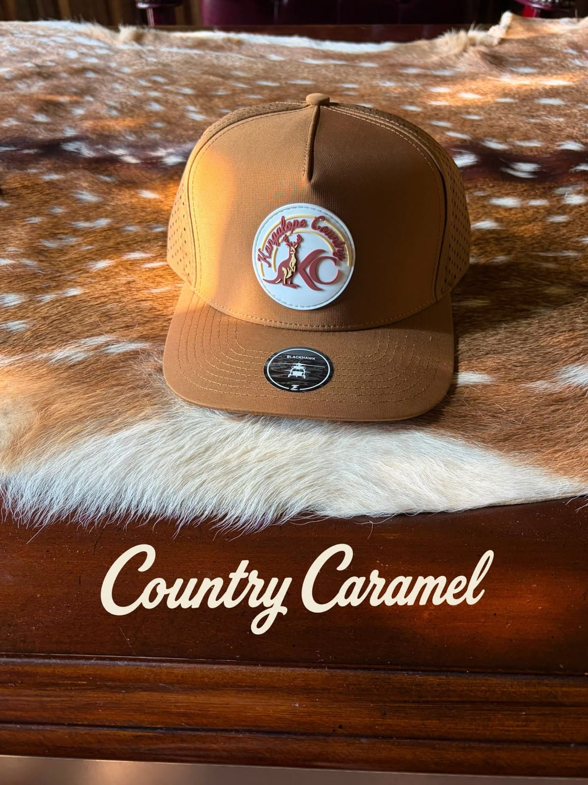 Caramel Country hat styled on a deer hide, studio shot