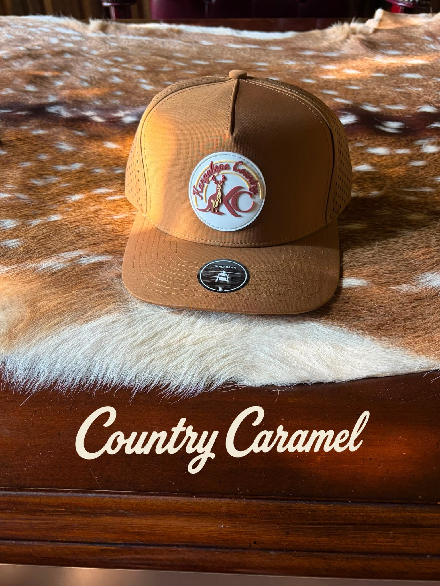 Caramel Country hat styled on a deer hide, studio shot