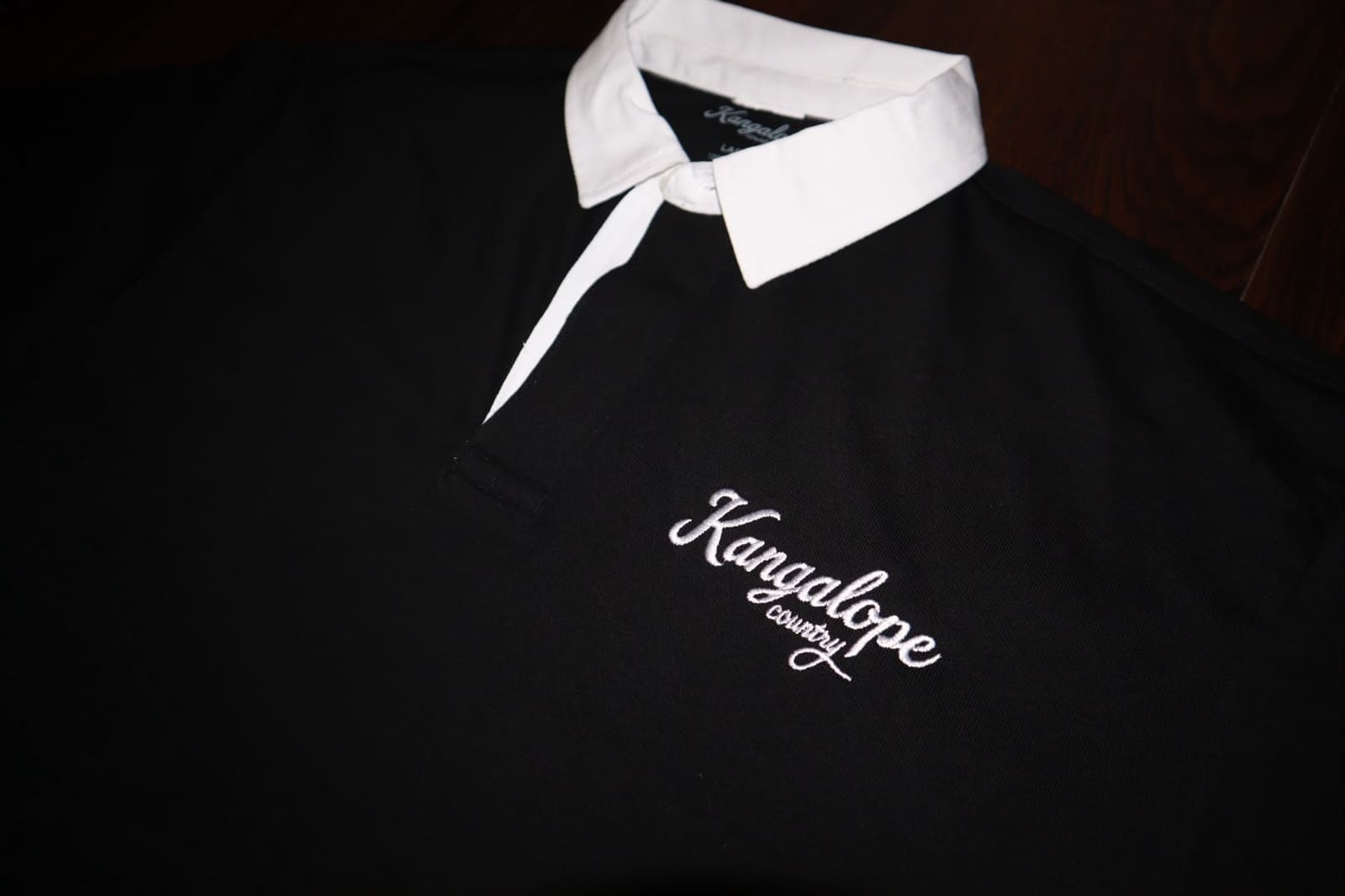 Close-up of the embroidered Kangalope Country logo on the rugby jersey